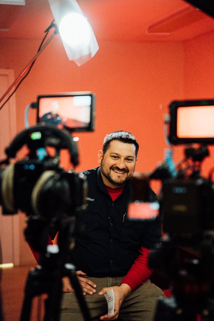 McCoy Visuals cinematographer adjusting camera settings during a brand video production shoot