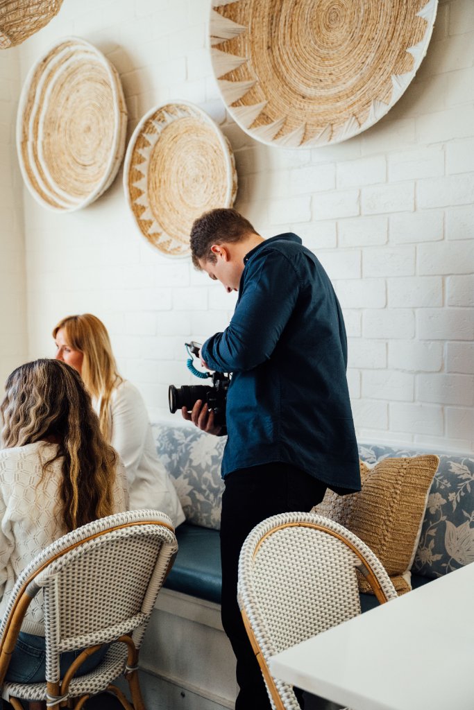 McCoy Visuals cinematographer adjusting camera settings during a brand video production shoot