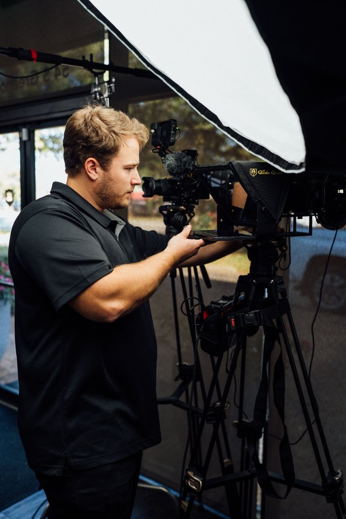 McCoy Visuals camera operator framing a cinematic shot during a commercial production