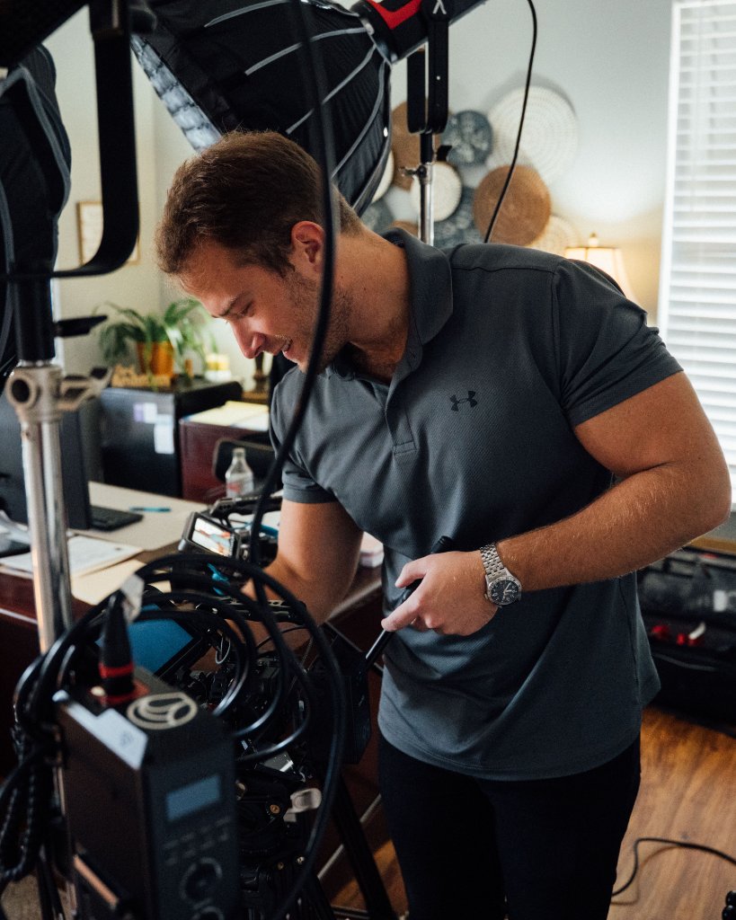 McCoy Visuals cinematographer adjusting camera settings during a brand video production shoot