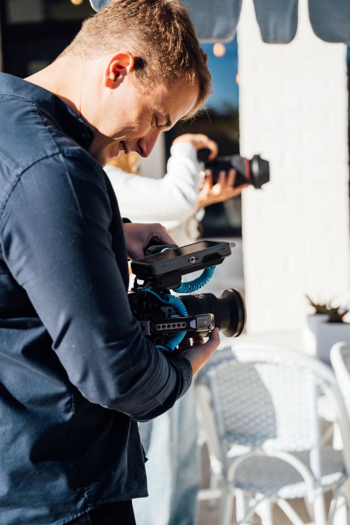 McCoy Visuals camera operator framing a cinematic shot during a commercial production