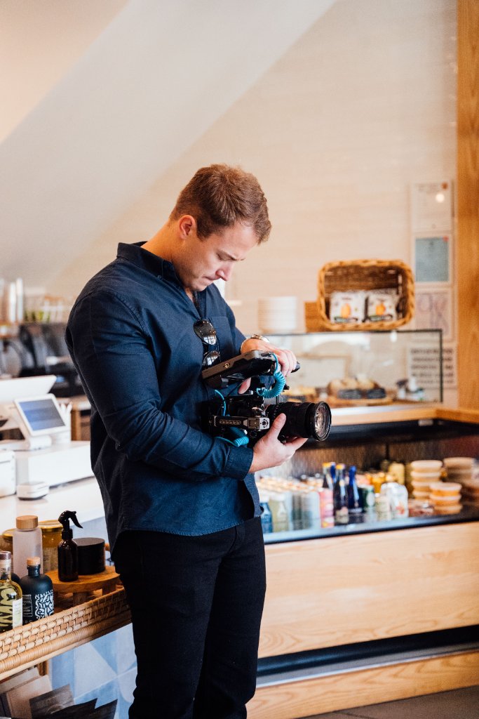 McCoy Visuals camera operator framing a cinematic shot during a commercial production