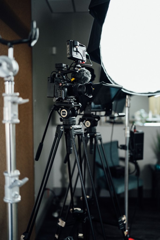 McCoy Visuals cinematographer adjusting camera settings during a brand video production shoot