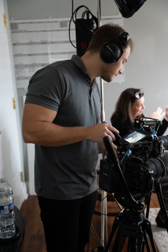 McCoy Visuals camera operator framing a cinematic shot during a commercial production