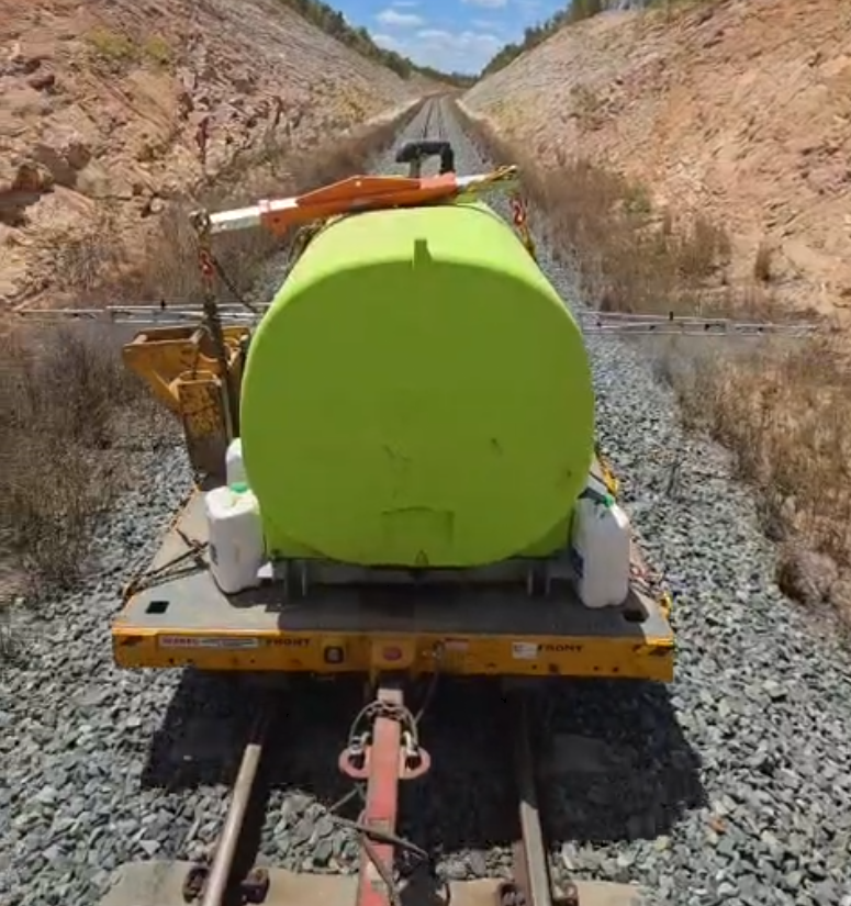 Spray tank unit on a rail trailer in a cutting