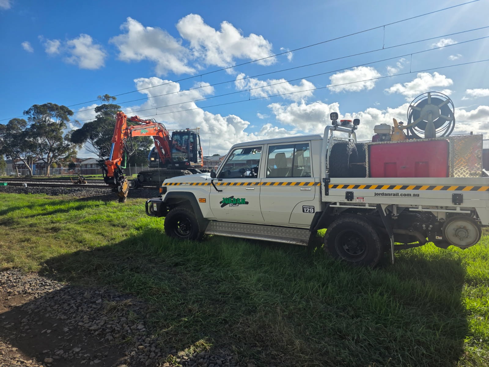 Hi-rail spray ute with clean water reel on the job
