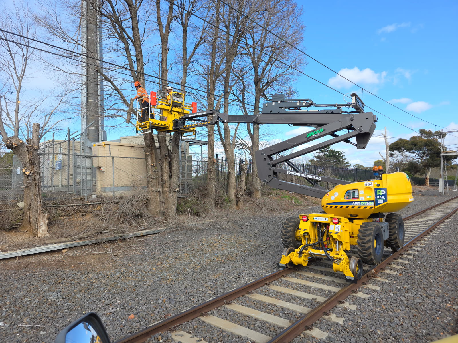 Hi-rail EWP clearing trees near overhead lines