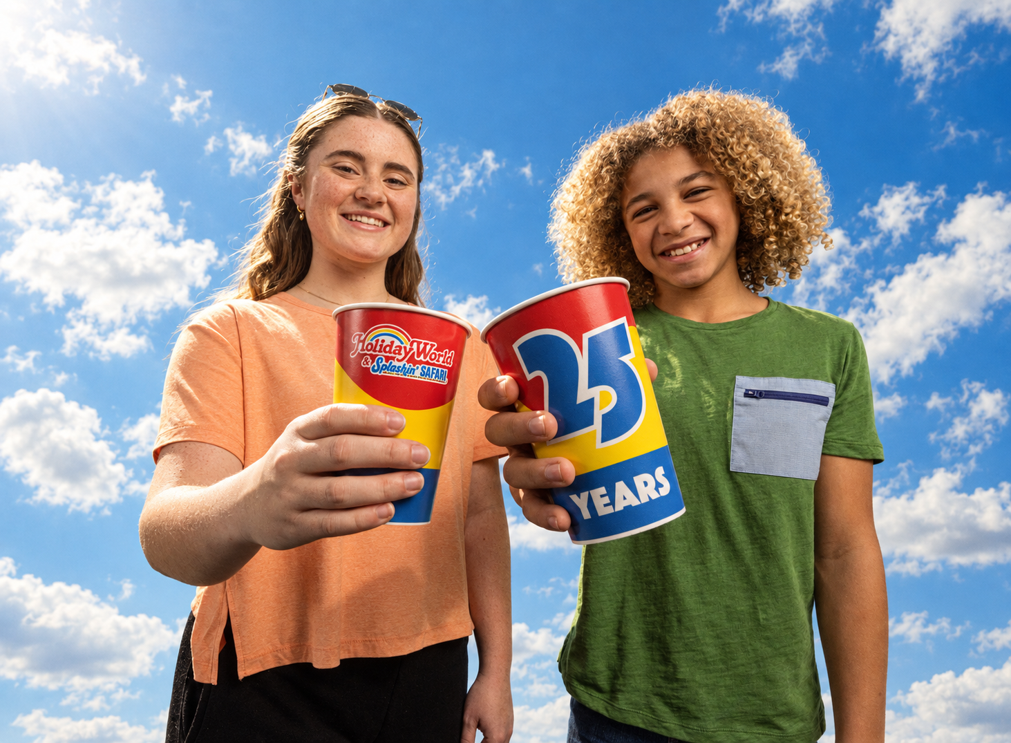 Two guests raising Holiday World 25th anniversary cups