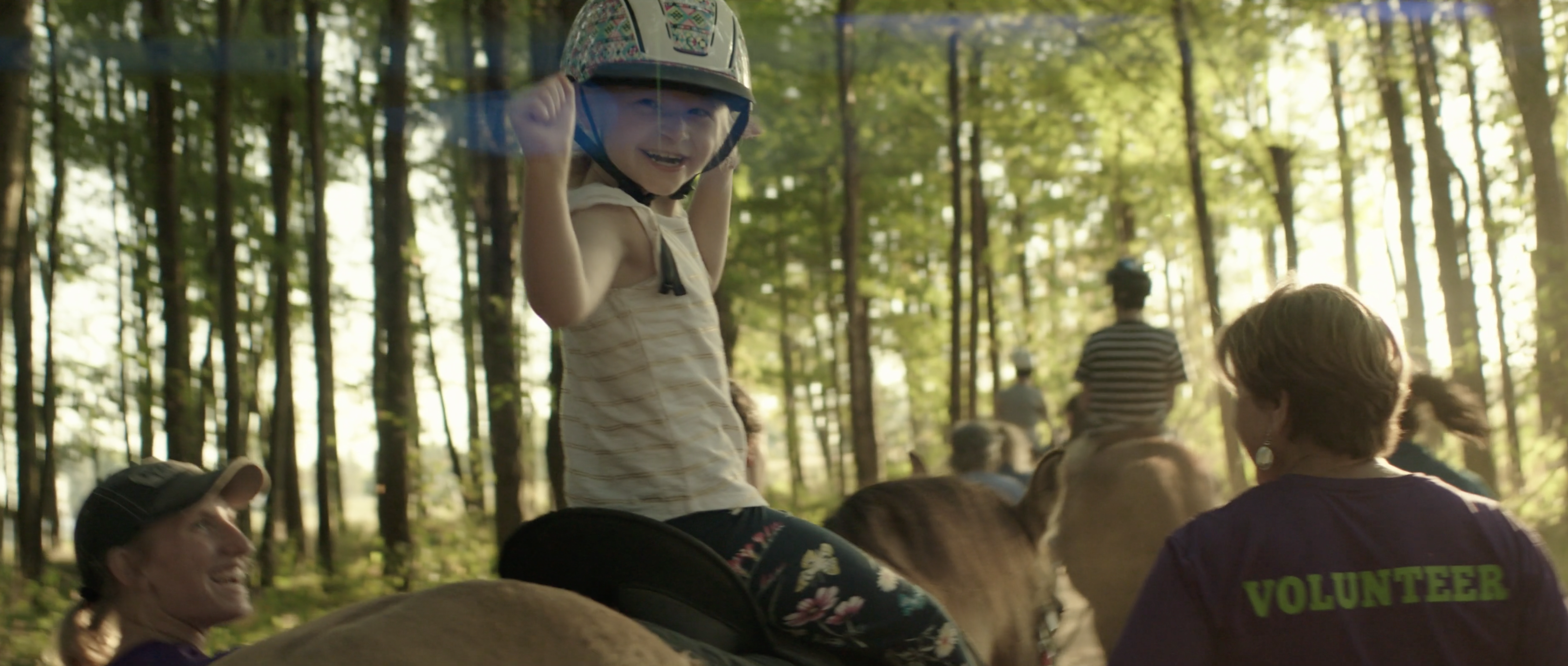 Play the Dream Riders of Kentucky brand video, a young rider on horseback with volunteers