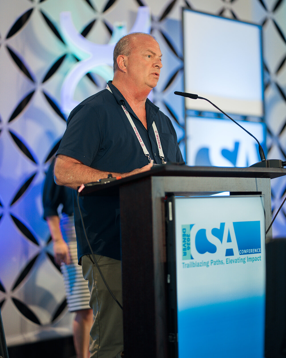 Scott Fischer speaking at the CSA Conference podium in Denver