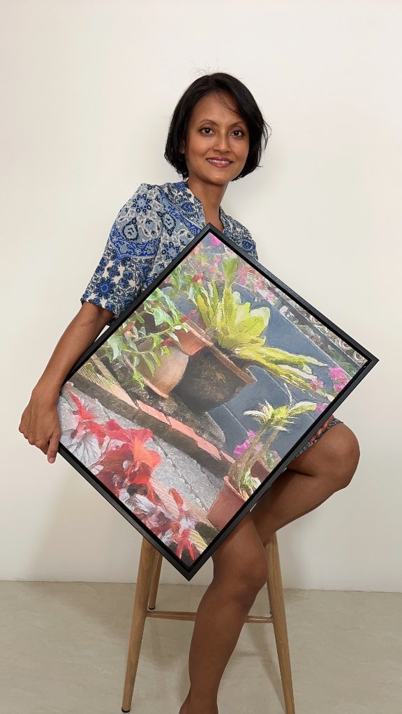 Nealda Yusof, co-founder of Artworksoft, holding an artwork