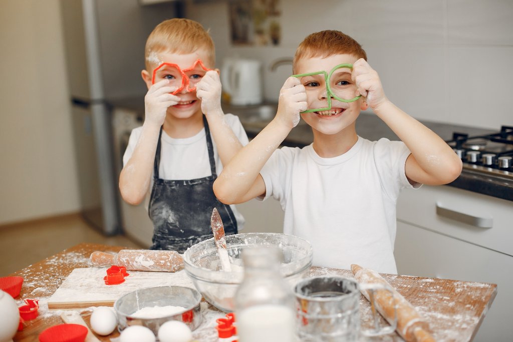 Two children laughing and baking together — hands-on home education at OpenSpace Waterlooville