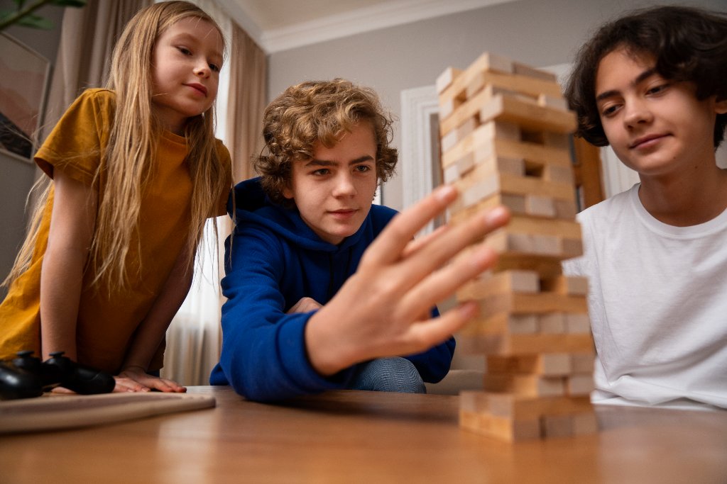 Children playing Jenga together at OpenSpace Beyond the Bell after-school club, Waterlooville