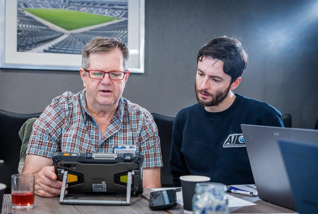 Trainer coaching attendee at AI task
