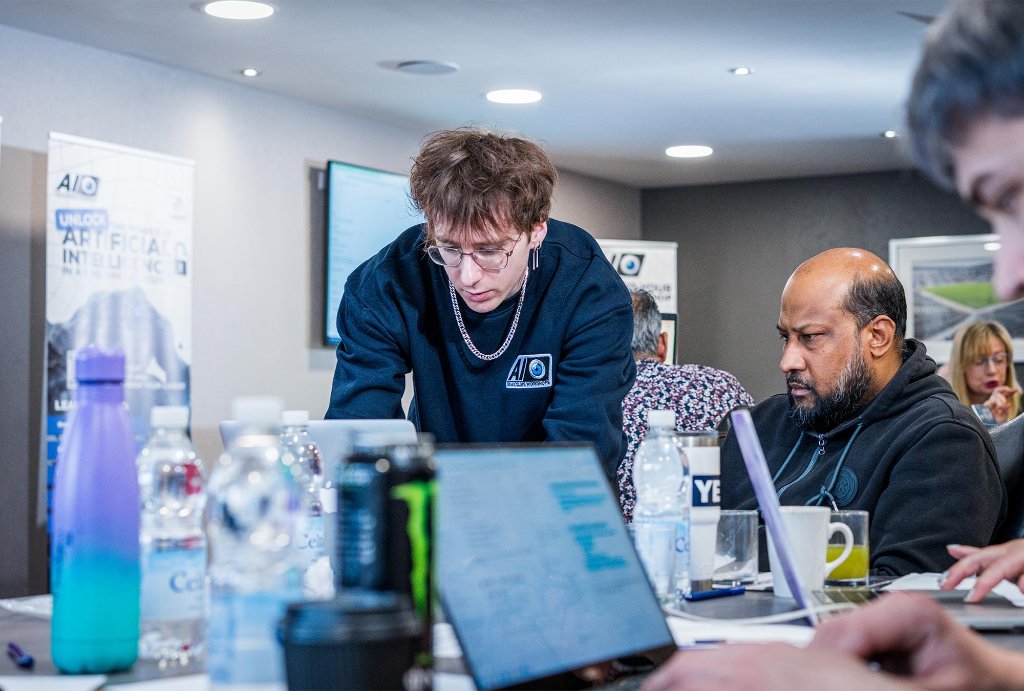 Team member coaching attendee on MacBook