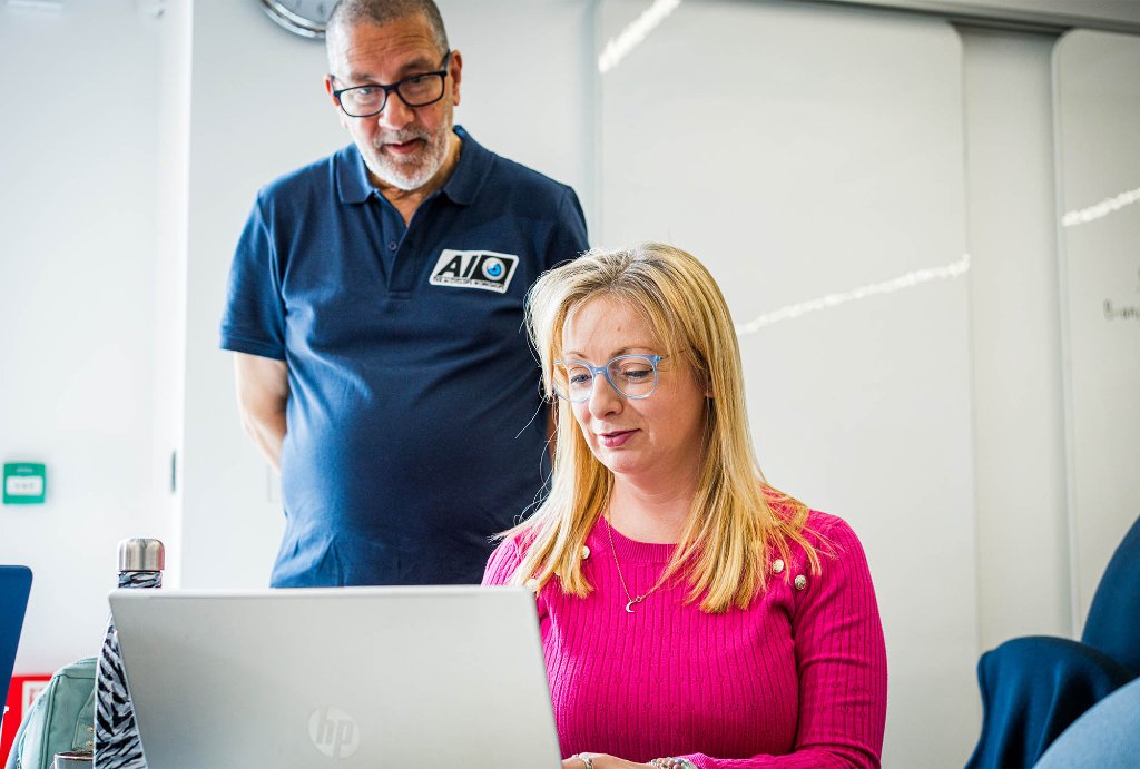 Trainer at laptop with attendee