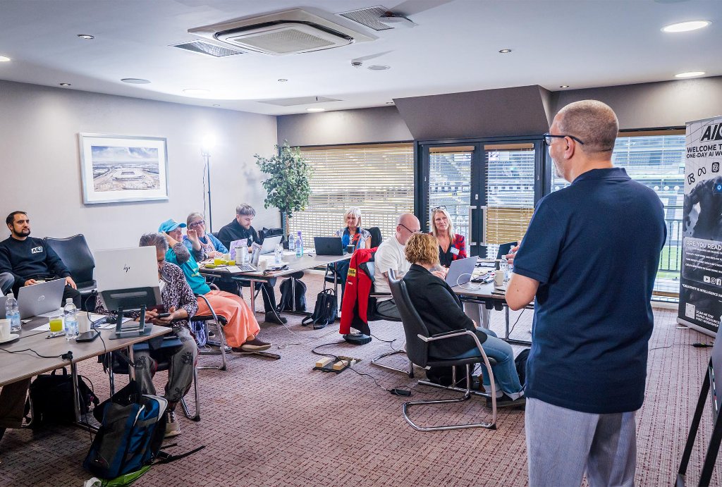 Trainer coaching attendee 1-to-1 at laptop