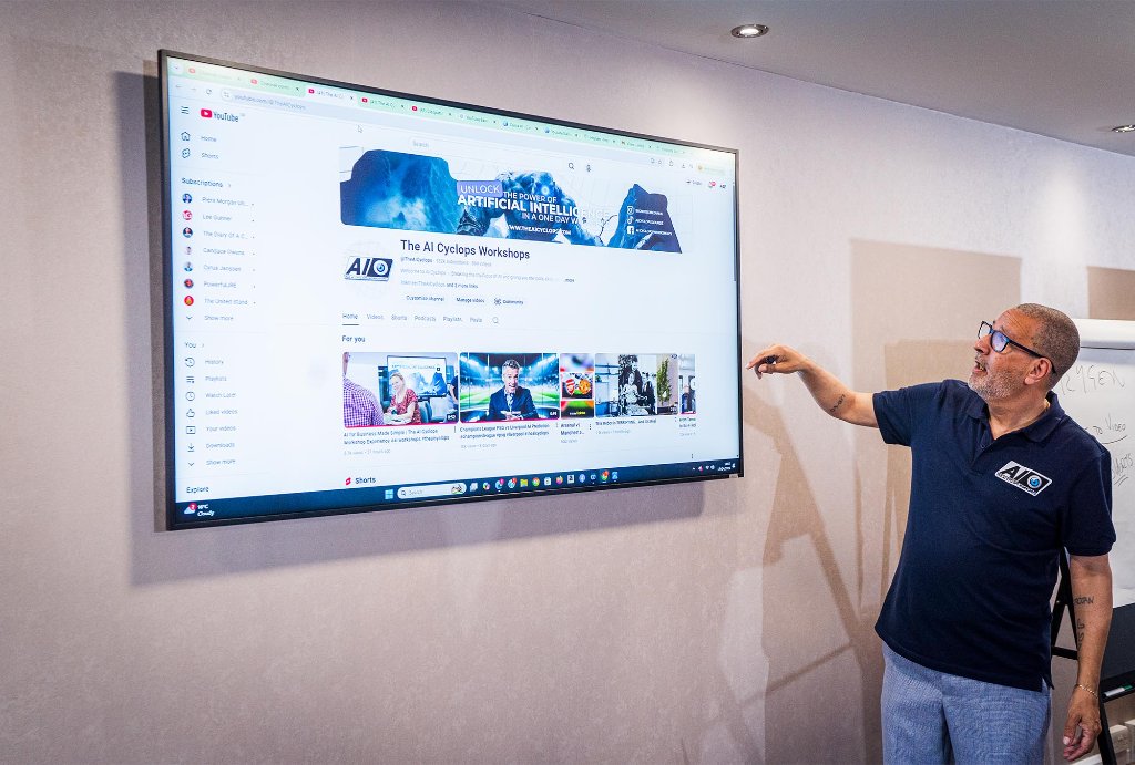 Trainer pointing at YouTube channel on screen