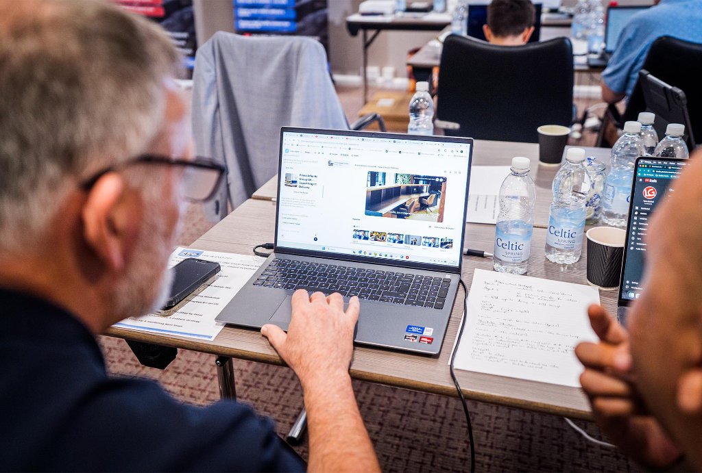 Attendee working on laptop close up