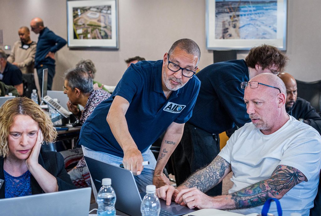 Trainer coaching attendee on AI platform