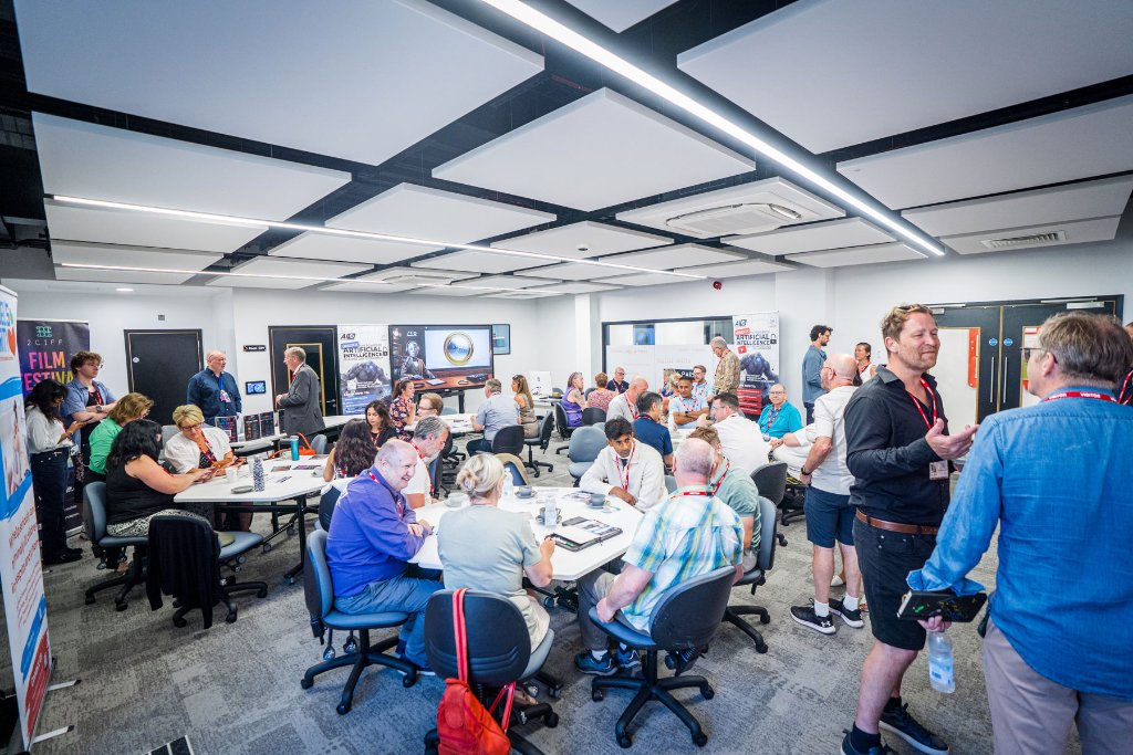 Attendees networking at The AI Cyclops Business Club event in a bright modern conference room