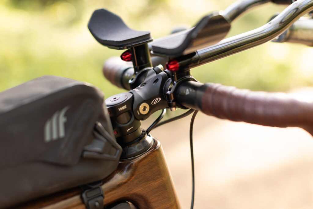 USE Vybe adjustable stem and cockpit on Zafi wooden bike with Tailfin handlebar bag