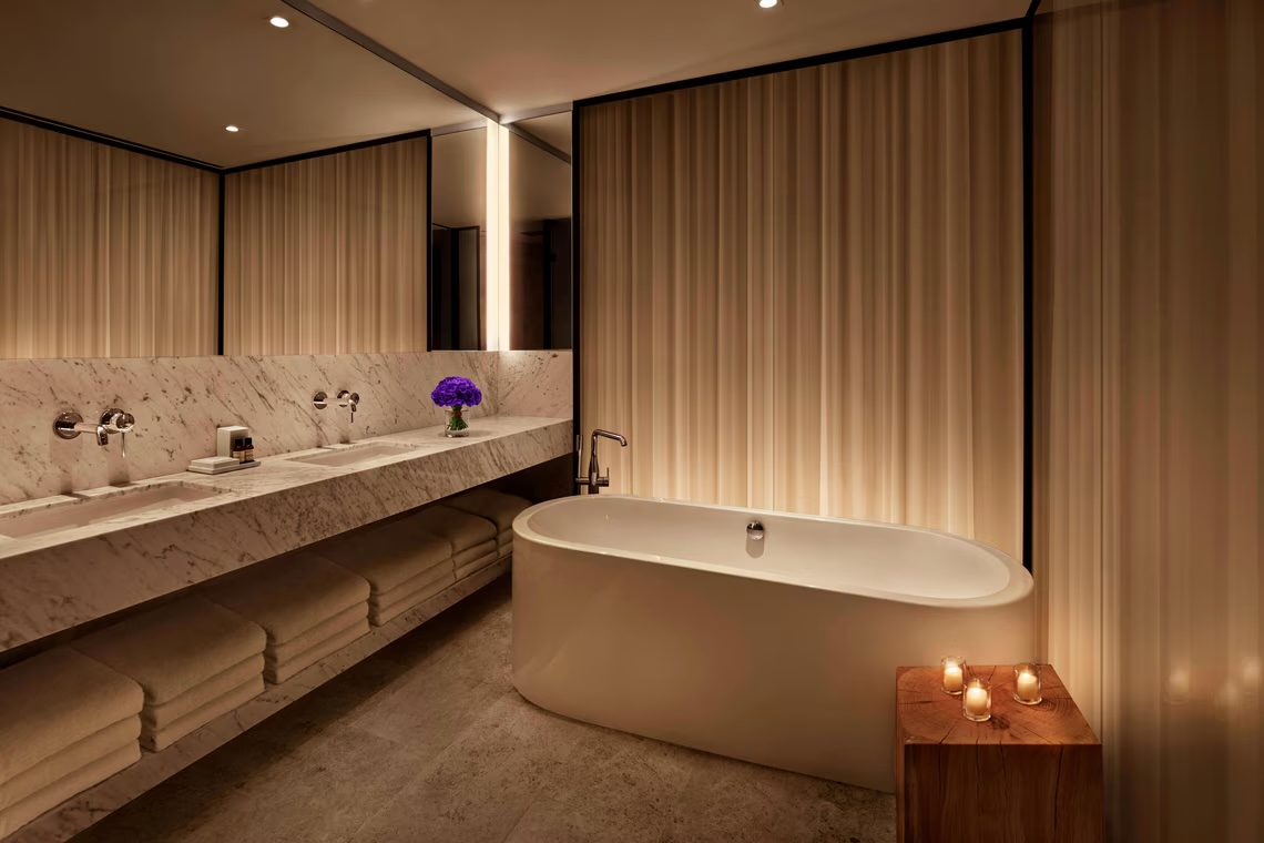 Deluxe Room bathroom — freestanding tub, marble double vanity and Le Labo amenities