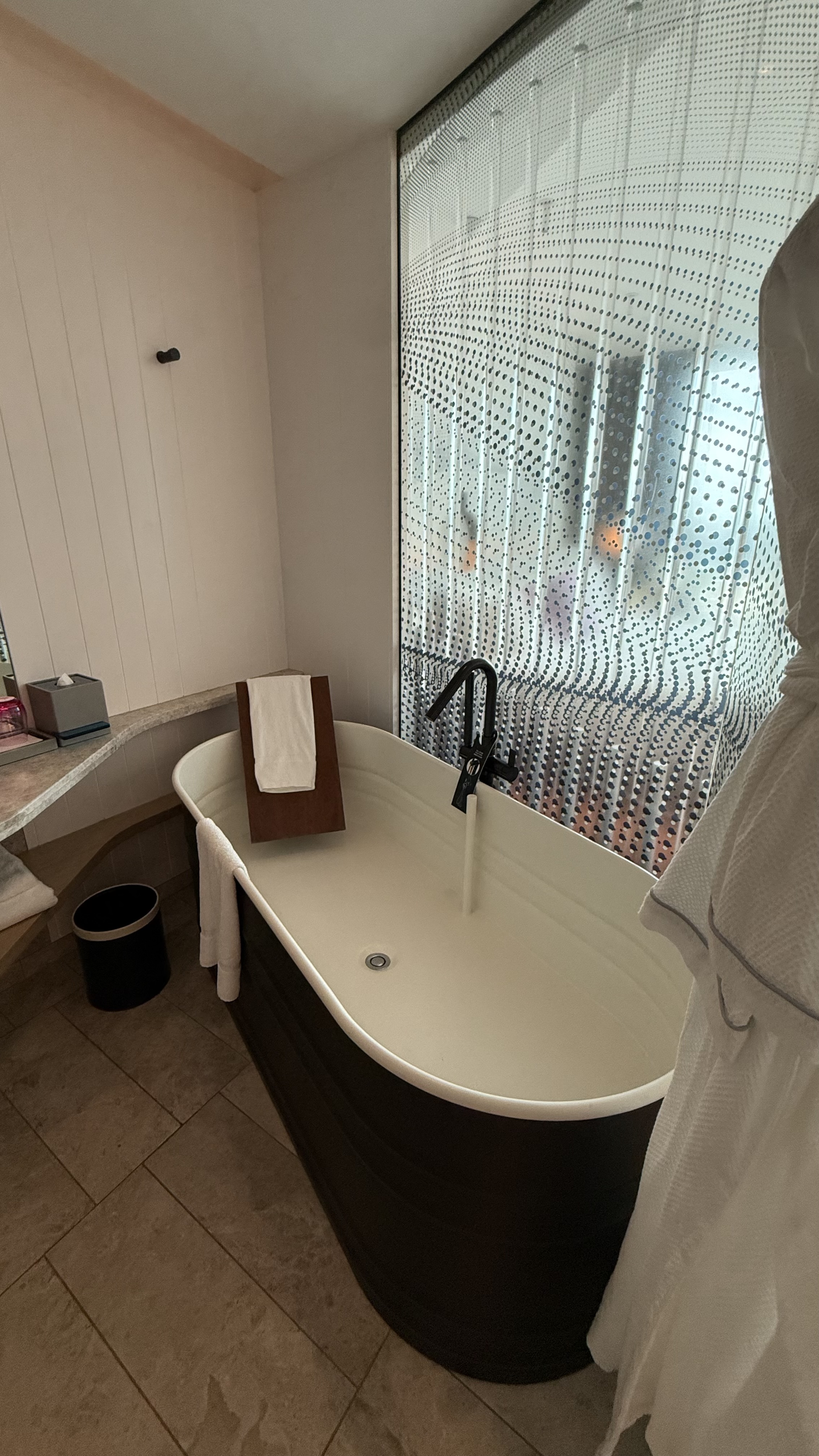 Bathtub from another angle — the bead curtain screen and vanity area
