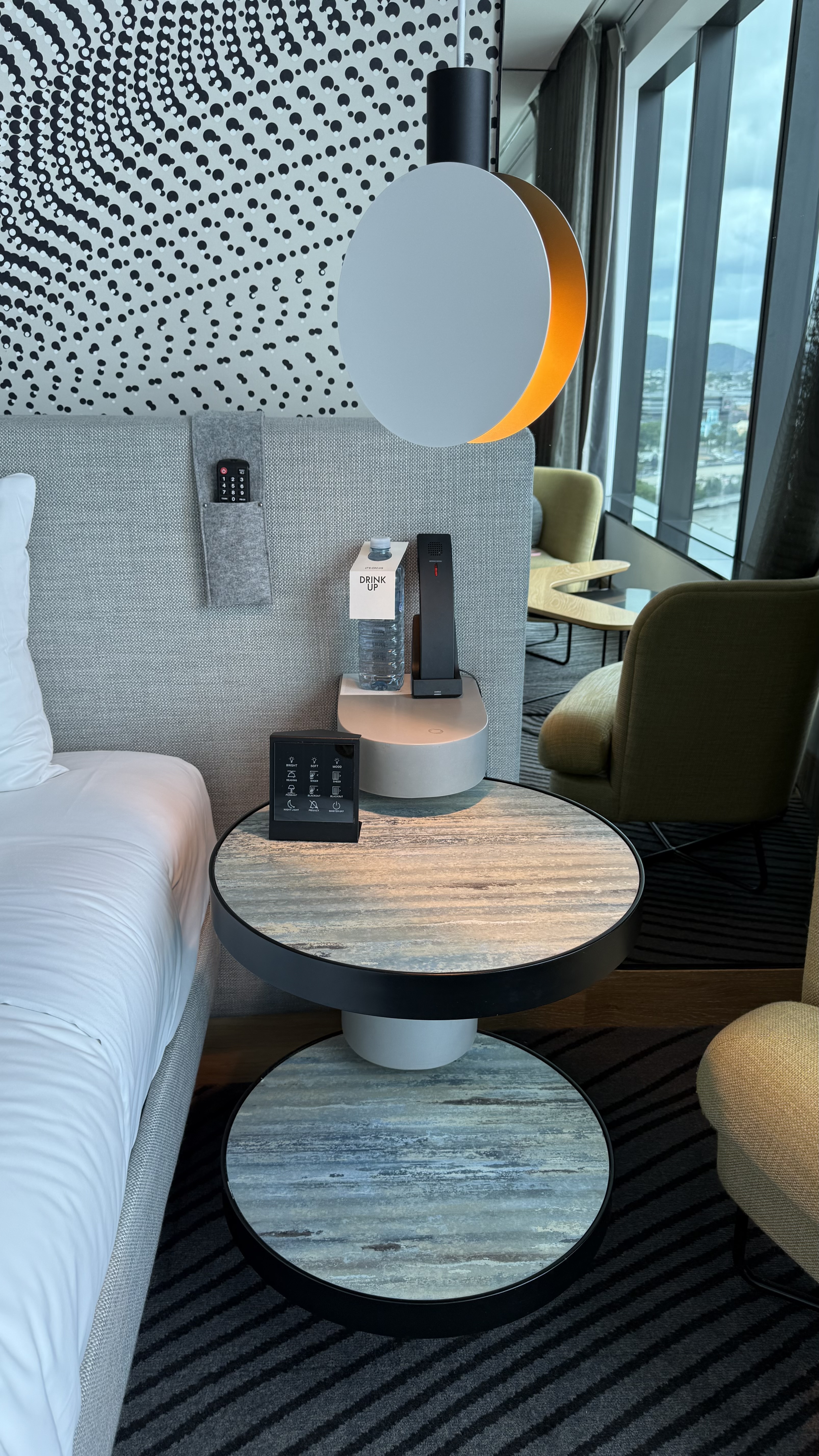 Bedside — dual-level circular table, bottled water, touchscreen controls