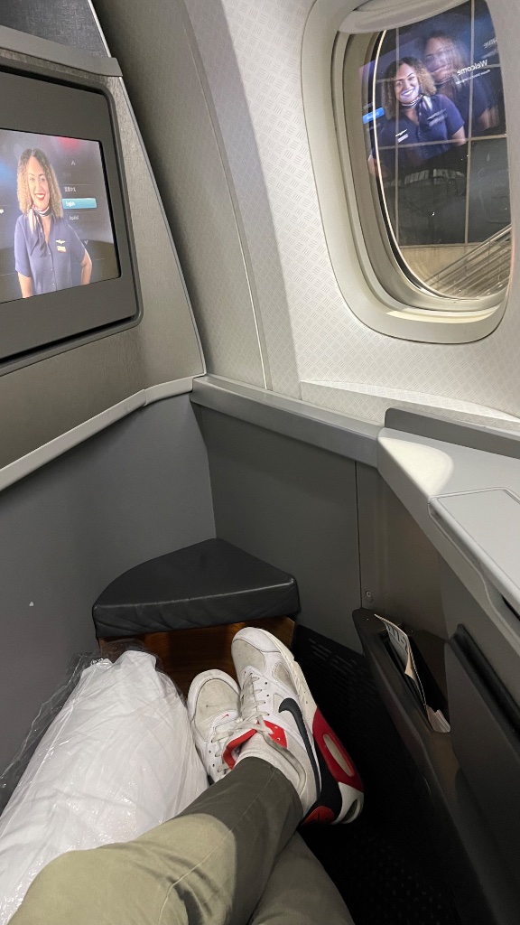 777 Business Class cabin — clean grey tones, herringbone layout