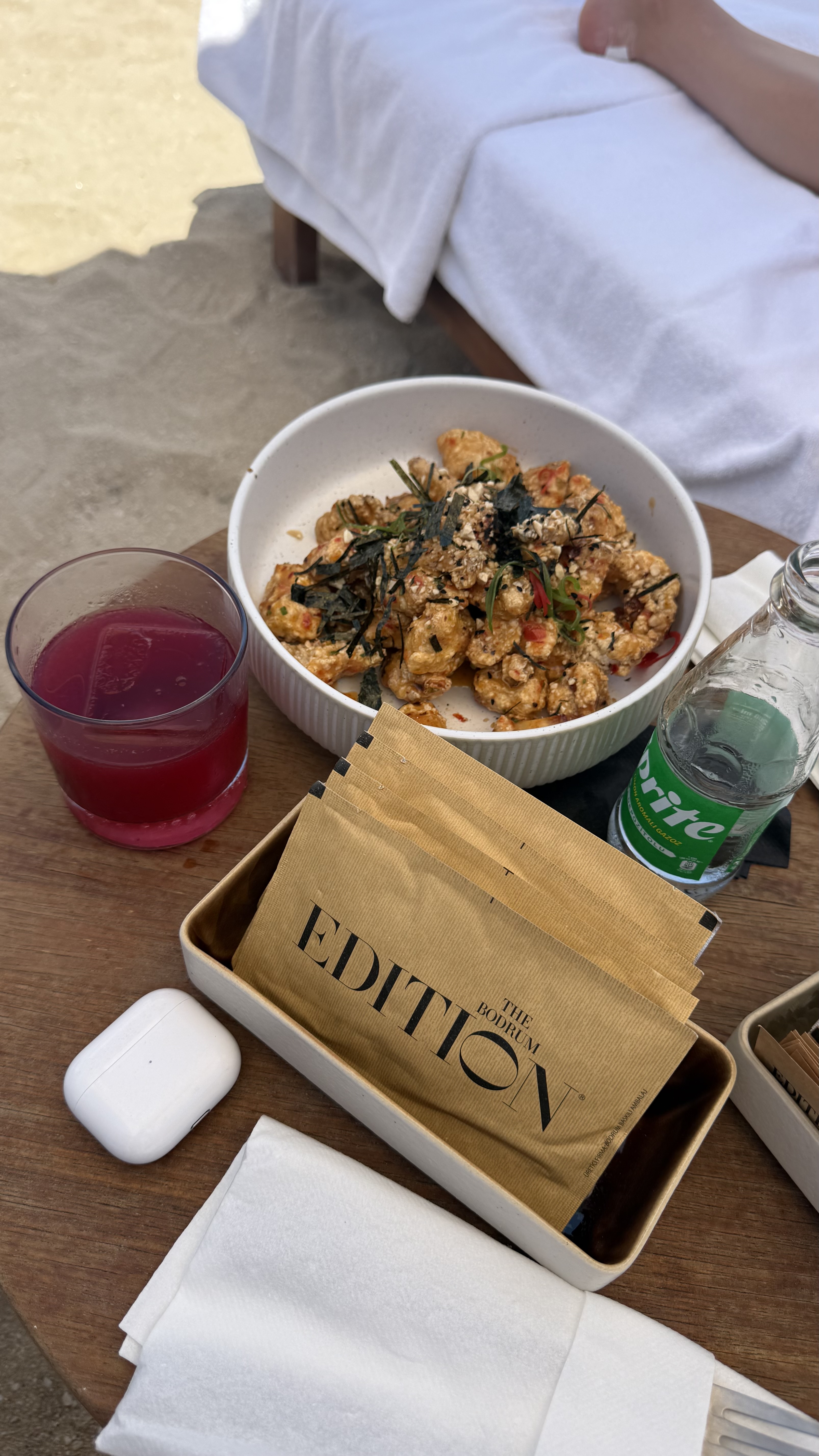 Lunch on the beach — the Edition chicken with hibiscus cooler and branded napkins