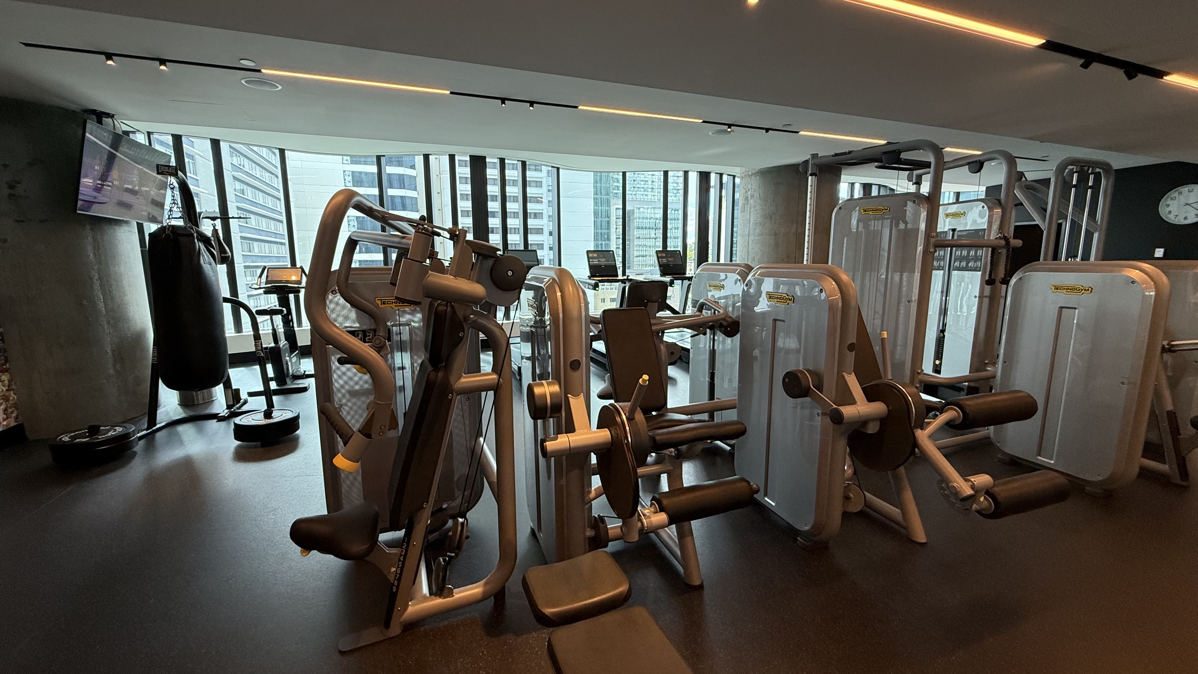 FIT gym — full Technogym machine floor, boxing bag and floor-to-ceiling windows