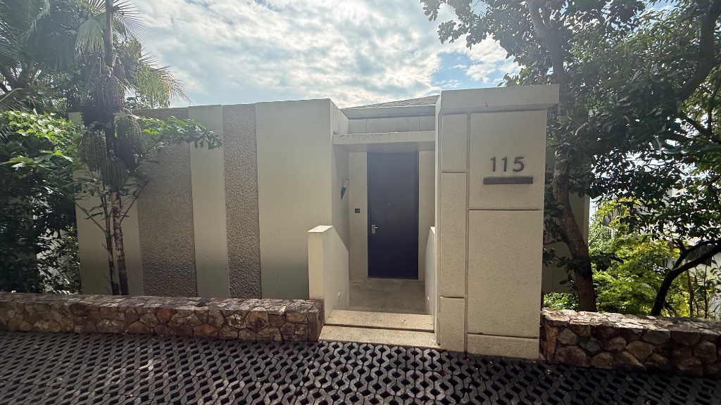 Villa 115 - entrance, set into the hillside with lush tropical planting