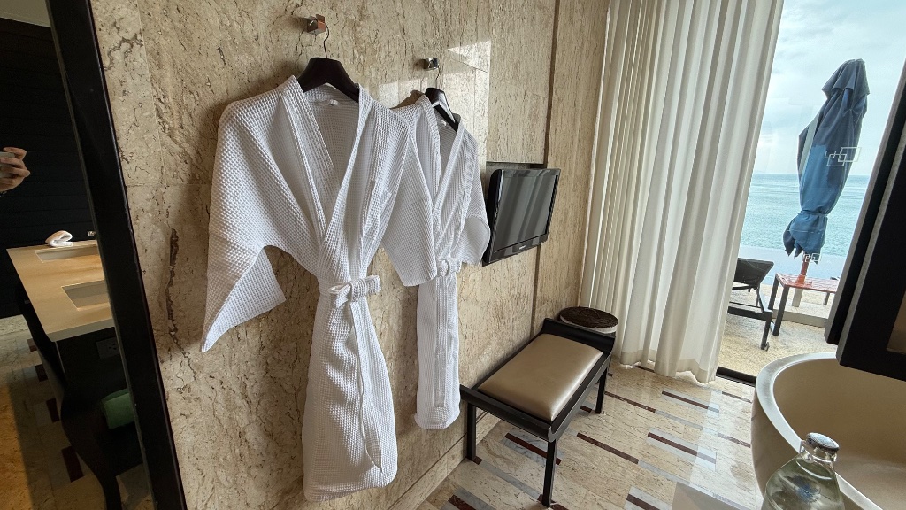 Waffle robes - hung in the bathroom with the pool visible beyond