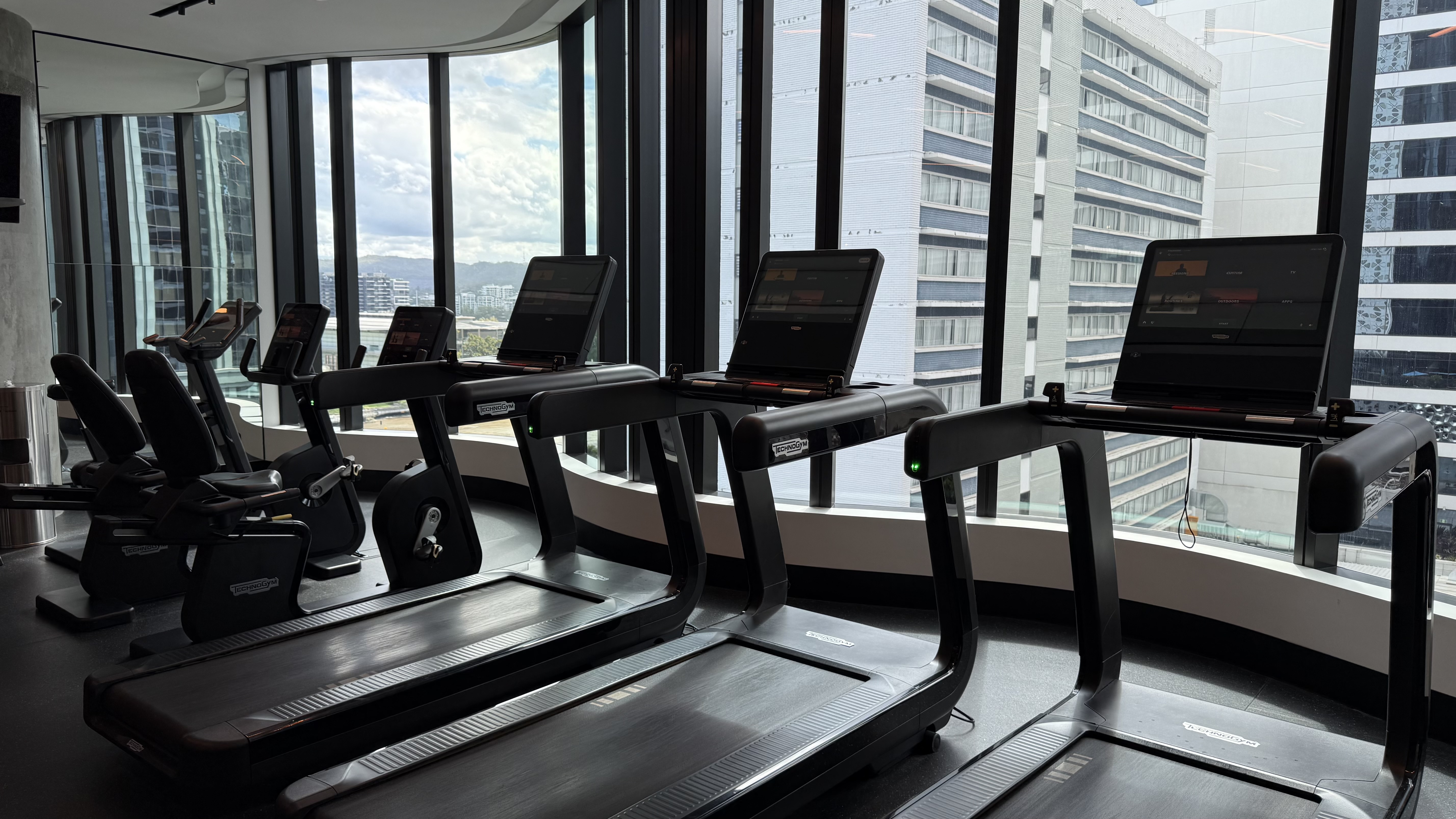 FIT gym cardio floor — Technogym treadmills, bikes and panoramic CBD views