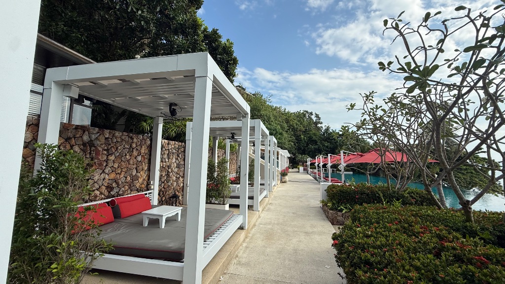 Private cabanas by the main pool, double daybed with fan and shade