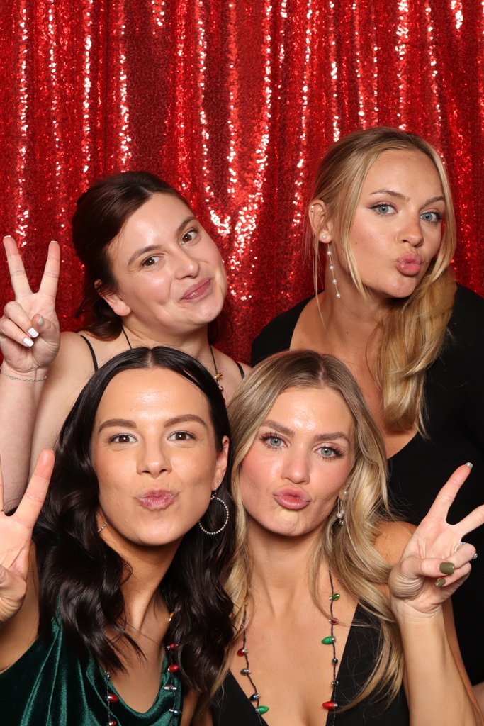 Guests having fun at an Indianapolis holiday party photo booth