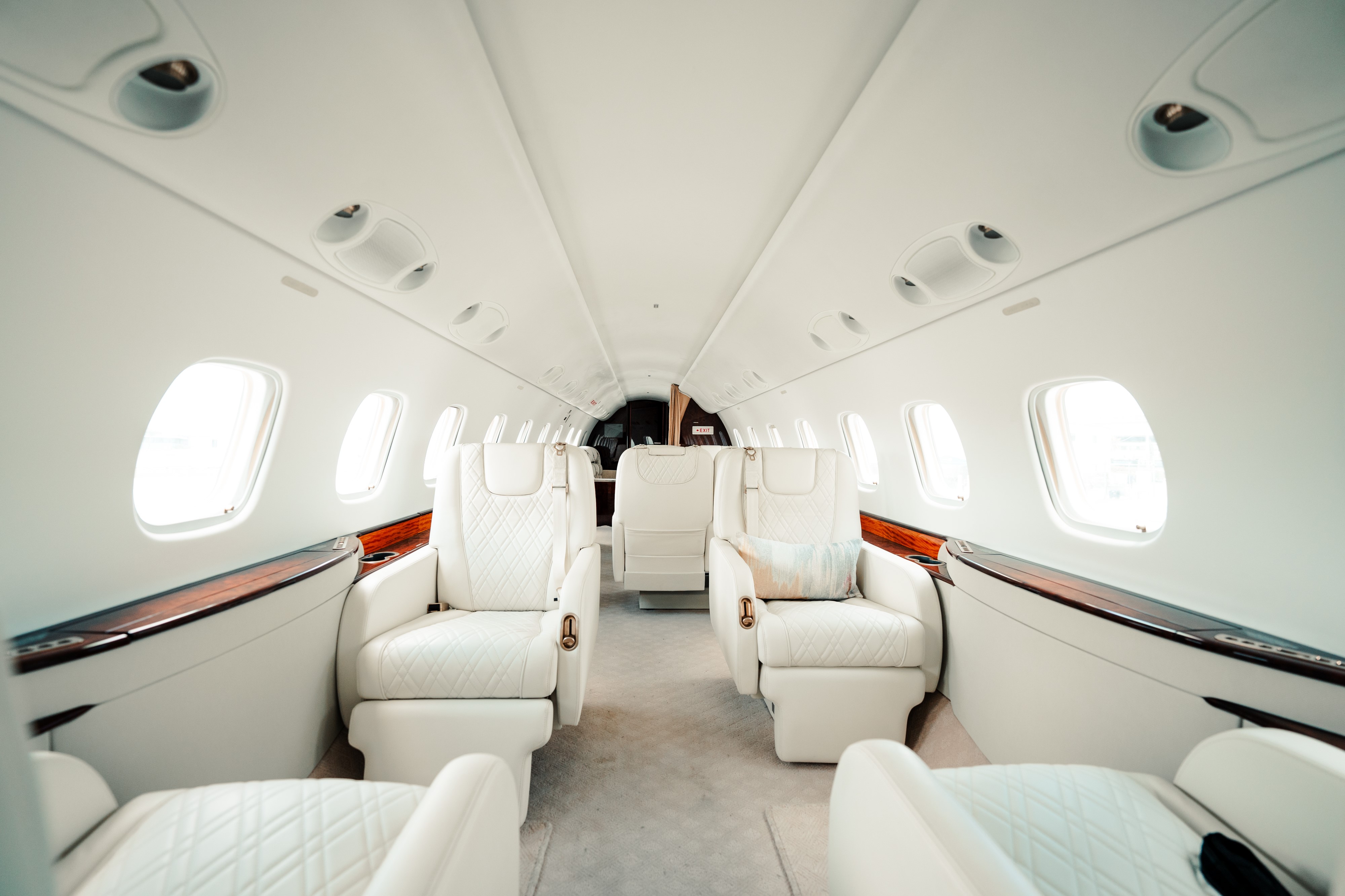 Legacy 600 private jet cabin with cream leather seating