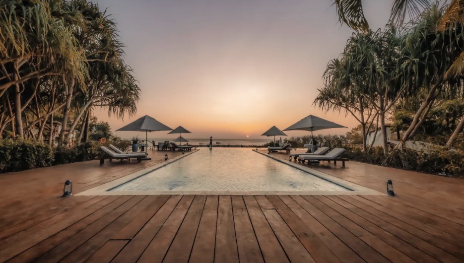 Infinity pool deck overlooking the ocean at sunset