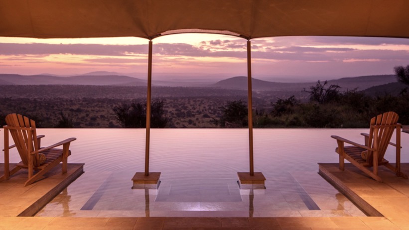 Infinity pool overlooking the East African landscape at sunset