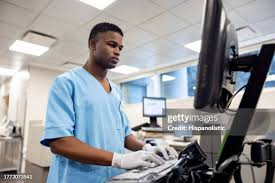 Hospital biomedical engineer managing medical equipment records on digital platform in Uganda