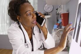 Pharmacy staff managing medication inventory with digital system in Uganda