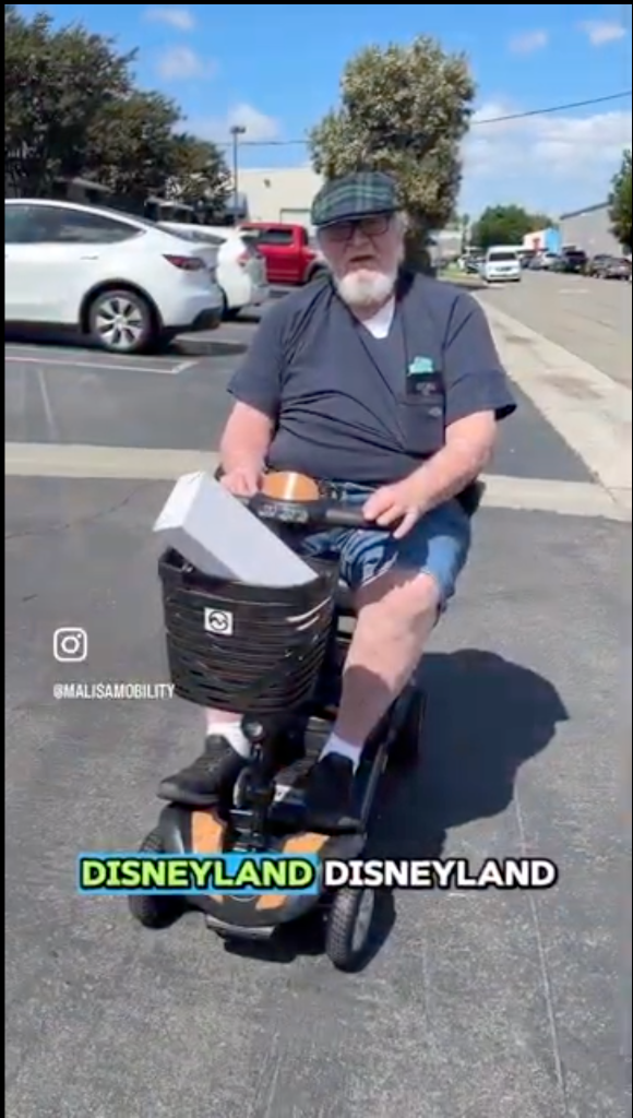 Customer on scooter at Disneyland