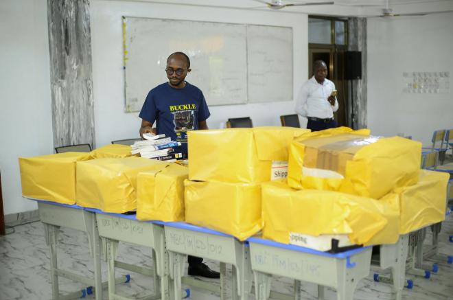Arranging books before the ceremony — preparing the donation at NARH-BITA College Hospital. — Buckle Foundation donation ceremony