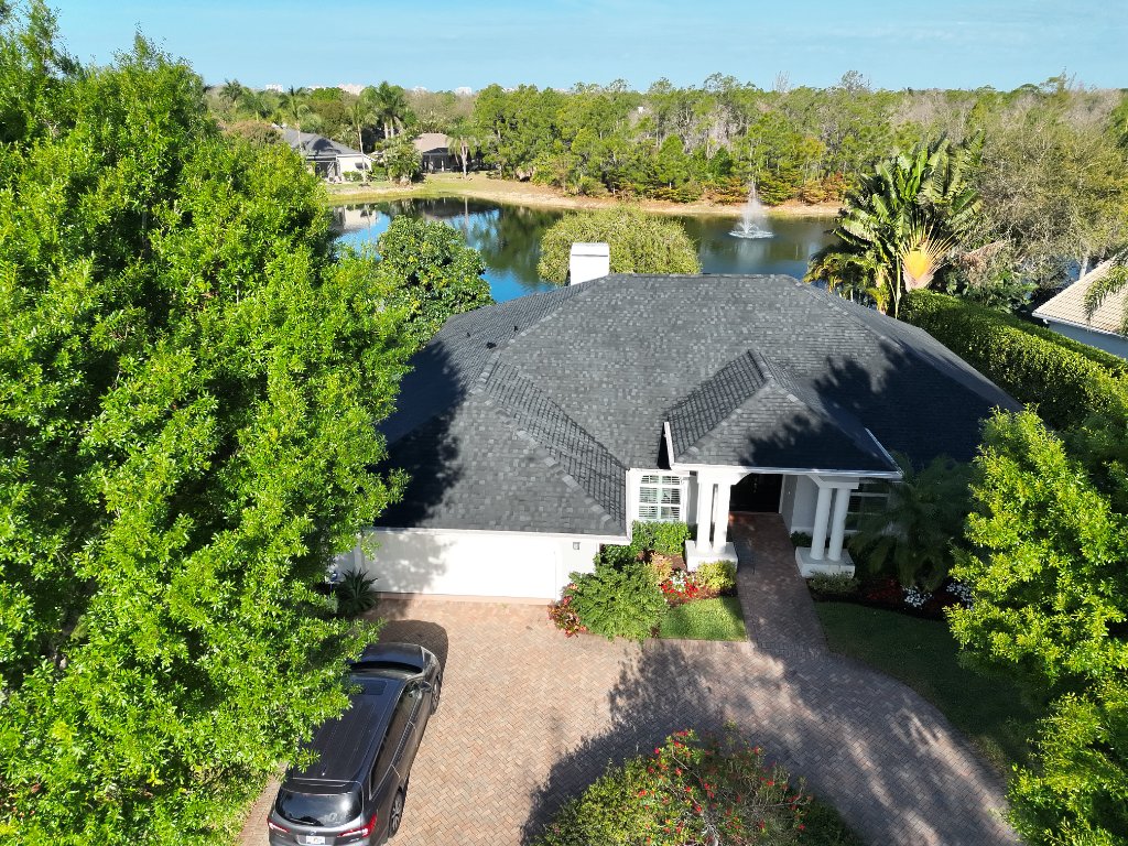TAMKO Titan HD Rustic Black shingle roof replacement Naples FL — aerial drone photo — Coastal Roofing and Waterproofing