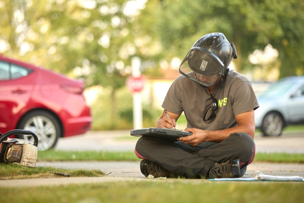 NPS crew member taking notes on site