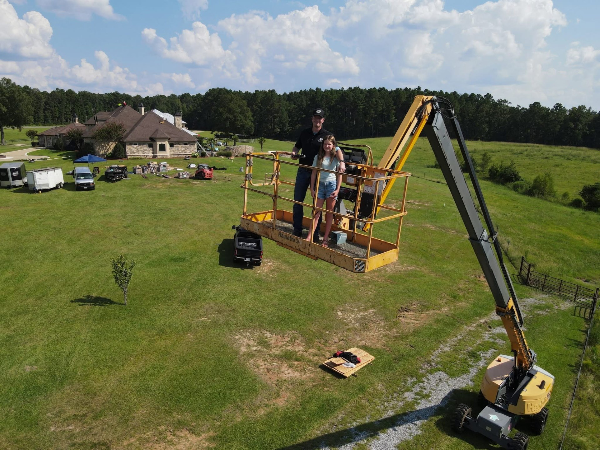 Boom lift providing elevated access over the residential yard