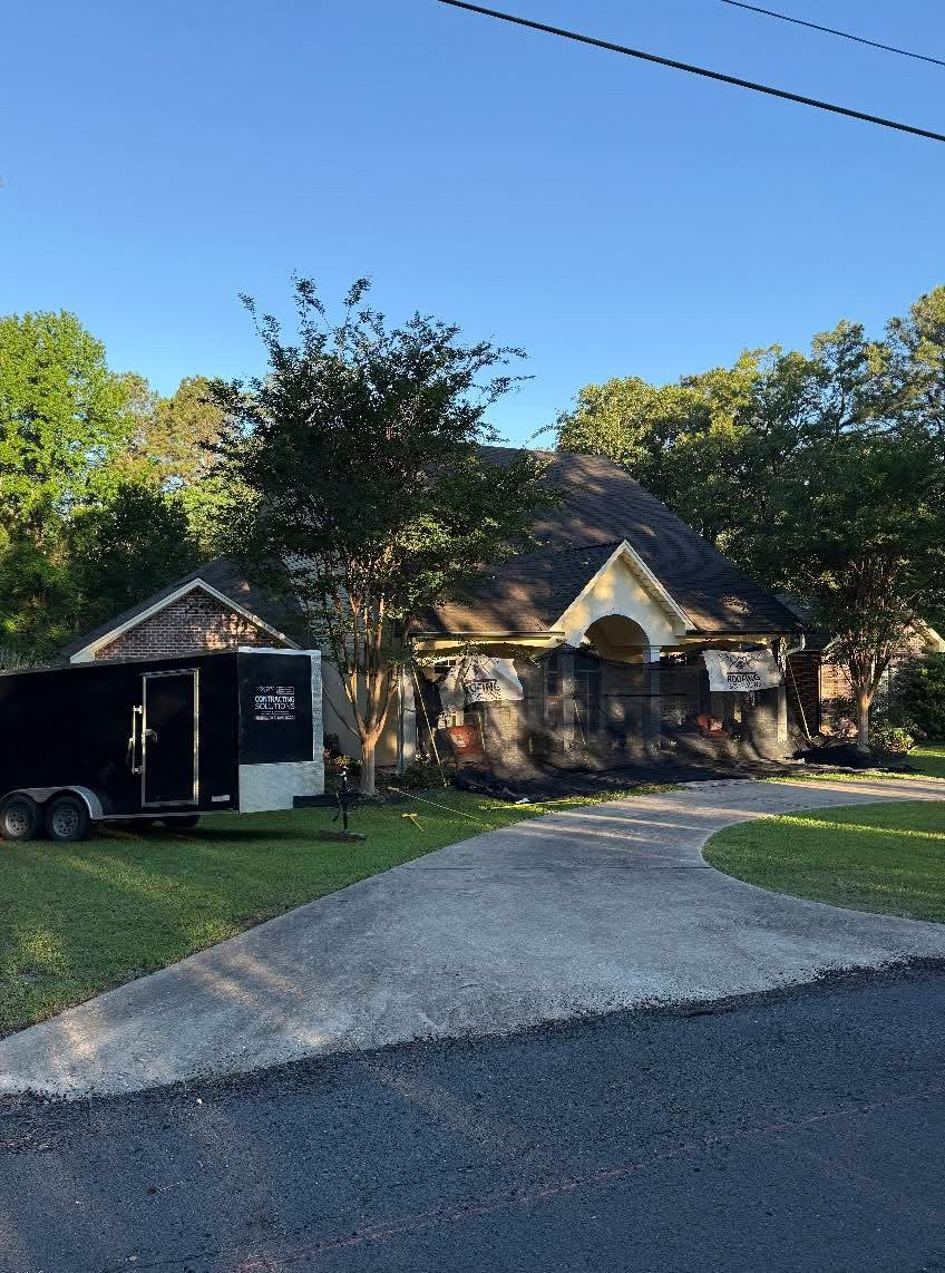 Single-story home mid-re-roof with Roofing Solutions debris screens on the porch