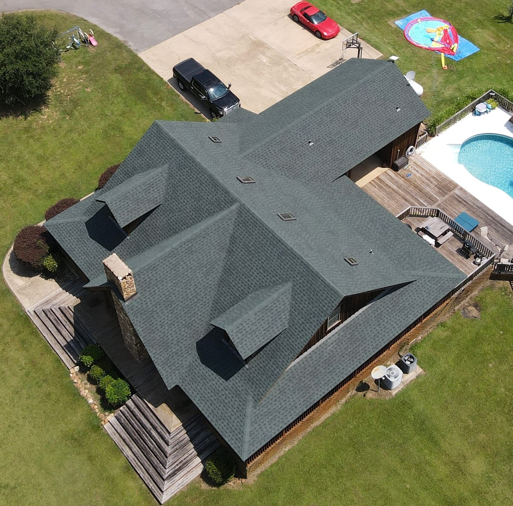Finished multi-level residential roof with dormers and pool deck