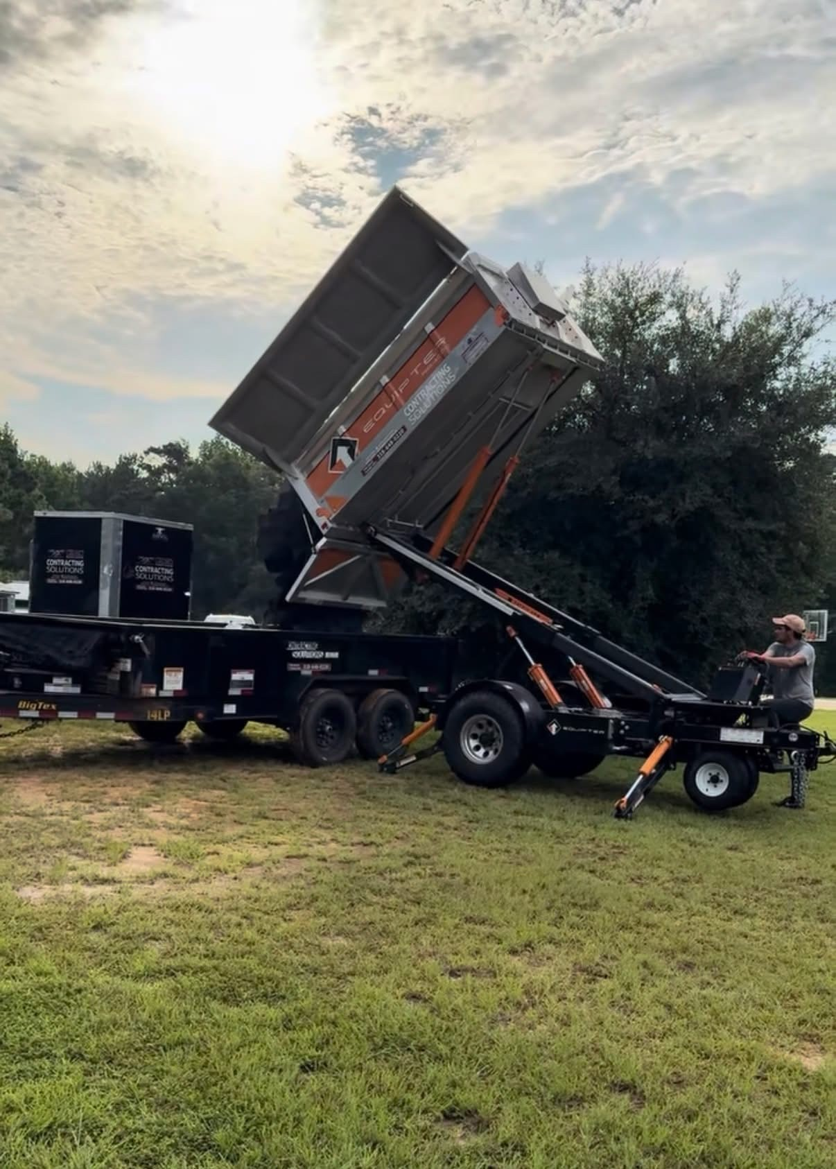 Equipter dump trailer raised on the lawn for debris offload